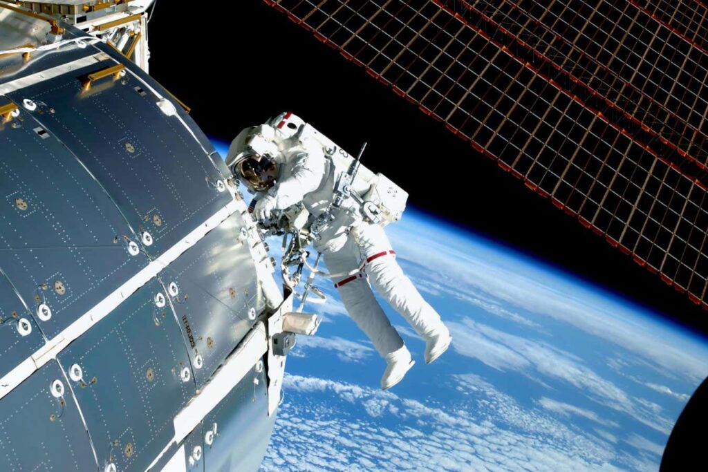 The astronaut in an outer space, at the ISS, repairs and makes experiments. Elements of this image were furnished by NASA; Shutterstock ID 1478957909; purchase_order: -; job: -; client: -; other: -